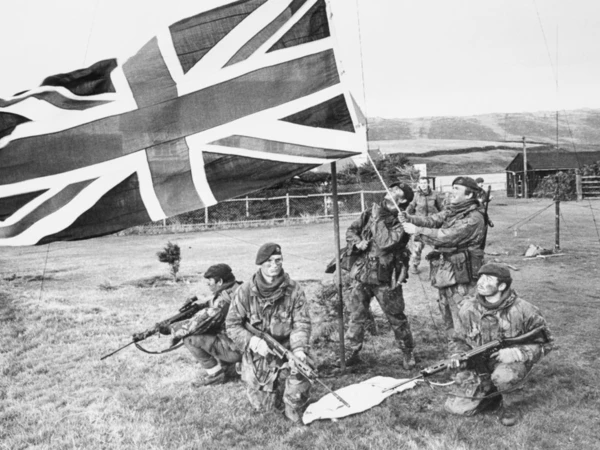 Marines of 40 commando raising the union flag in the falkland islands after the Argentine surrender as seen on the Legasee educational trust website. The Falklands War project by Legasee Educational trust. UK Military video archive and Military history.